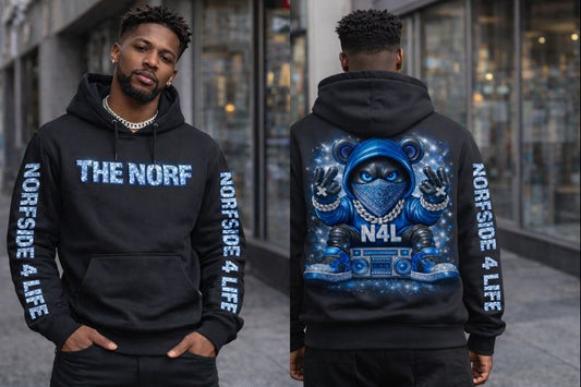 Person wearing a black hoodie with 'The Norf' and 'Norfside 4 Life' text, standing in front of a building.